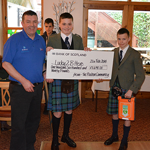 Ross receiving a donation cheque